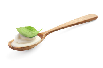 Spoon with delicious yogurt and basil isolated on white