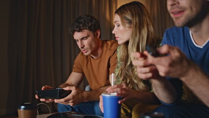 Closeup friends chilling home taking food drinks at evening. People relaxing