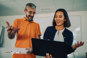 Female asian chinese team leader presenting project to caucasian male colleague