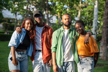 Happy contented group of african american friends stop walking looking at camera with smile....