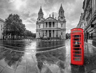 Saint Paul's cathedral and red telephone box on rainy day in London. England