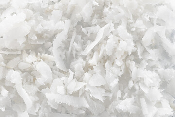 Fresh coconut flakes on white background, top view. Close-up