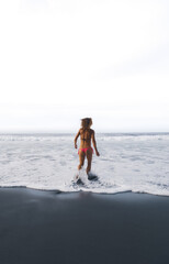 woman walks into the sea water