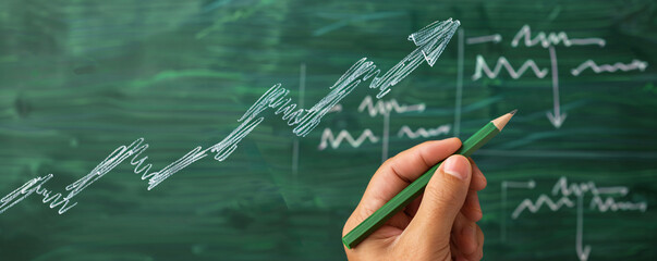 Hand drawing an upward trend graph with a pencil on a green chalkboard background - Powered by Adobe