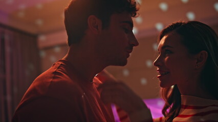 Sensual couple moving together at disco ball lights close up. Woman hugging man