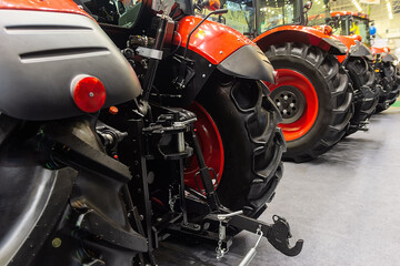 New agricultural tractors are sold for work in the field. Mechanical engineering, industry