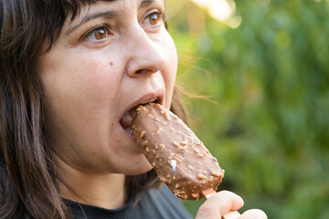 Young woman eating an ice cream bar