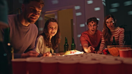 Young people competing party playing beer pong together close up. Friends game 