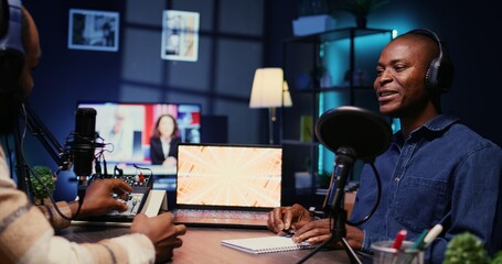 African american influencer recording podcast with man, talking in studio. Zoom in shot of cheerful...