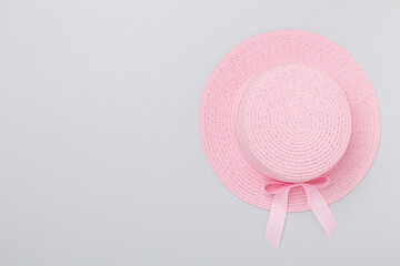 Pink hat on color background, top view. Summer concept