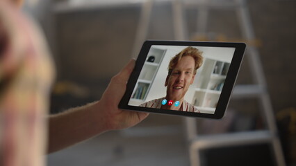 Closeup guys videocalling online indoors. Two best friends talking tablet cam