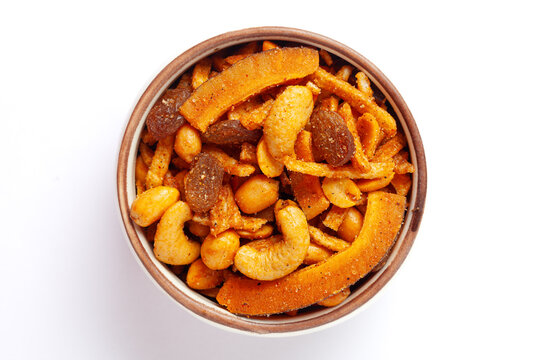 Close-up of  Shahi vrat or upvas or Fasting namkeen Mixture made from coconut,ground nuts, cashew, potato slice, peanut, Indian spicy snacks (Namkeen), served in ceramic bowl.