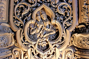 Wooden Carving Depicting Two Figures in a Floral Design demonstrates skill and artistry