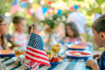 An American flag in front of a family celebrating the Fourth of July at a dinner table