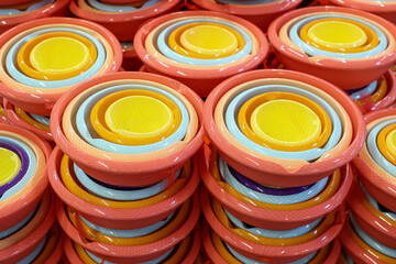 A stack of colorful bowls with a yellow bowl in the middle