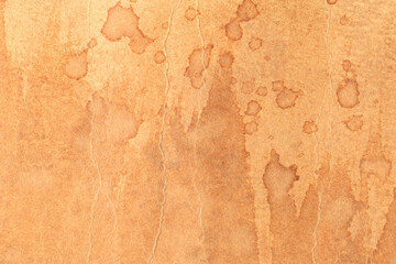 A brown surface with many stains and splotches, texture background of retro vintage yellowed paper