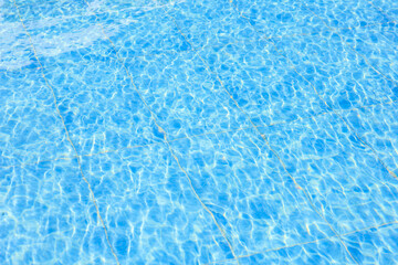 The water is calm and clear, reflecting the sky above