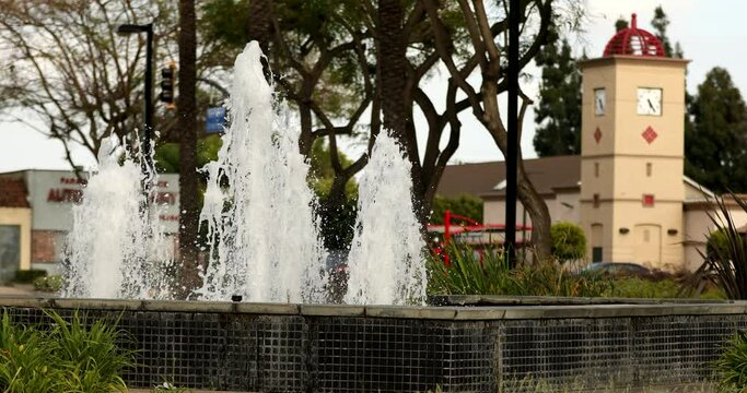 Palm lined view of a fountain in the civic center of downtown Paramount, California, USA.