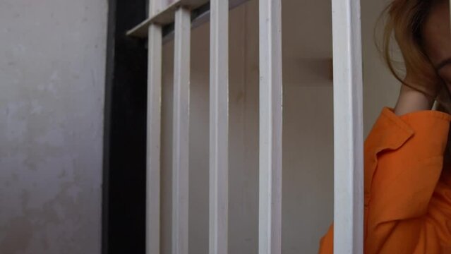 Female prisoner locked in jail,Being the scapegoat for a case that wasn't done,want freedom from captivity,Asian woman very sad and stressed