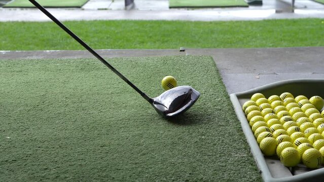 slow motion show hitting a driver shot at the driving range