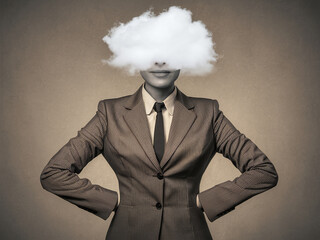 Person in suit with cloud obscuring head, hands on hips, against plain background.