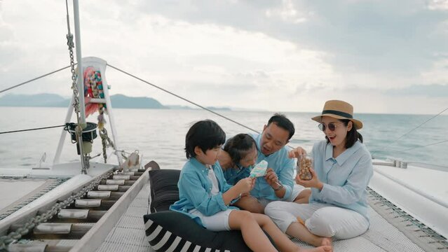 Asian family is having fun on a yacht during family vacations, family relationships

