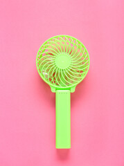 Modern manual fan on pink background