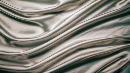 Close-up of smooth, flowing silk fabric with soft folds and a shiny texture.