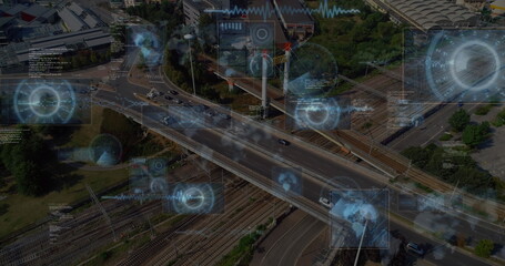 Image of round scanners and data processing against aerial view of city traffic