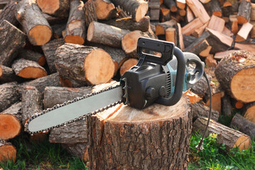 One modern saw on wooden log outdoors