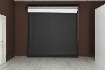 Empty black photo background. Professional studio equipment