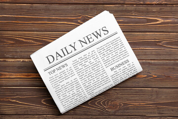 Daily newspaper on wooden background