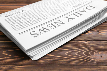 Daily newspaper on wooden background