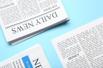 Different newspapers on blue background