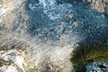 Aerial view of a winter snow-landscape. Winter forest texture. Aerial view. Aerial drone view of a winter landscape. Snow covered forest.