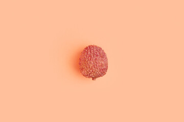 Tasty litchi fruit on beige background