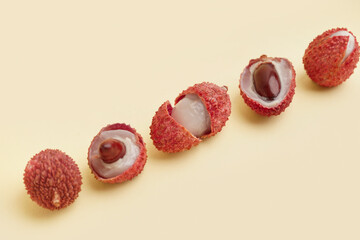 Tasty juicy litchi fruit on beige background