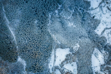 Aerial view of a winter snow-landscape. Winter forest texture. Aerial view. Aerial drone view of a winter landscape. Snow covered forest.