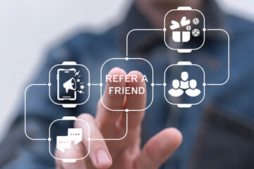 Man using virtual screen presses text: REFER A FRIEND. Referral marketing or affiliate marketing...
