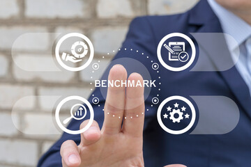 Man using virtual screen presses text: BENCHMARK. Business compare tool for improvement....