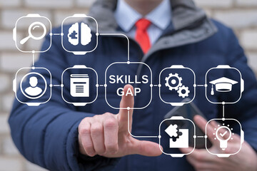 Business man working on virtual touch screen presses inscription: SKILLS GAP. Concept of Employee Skills Gap Analysis. Lack of Knowledge and Experience. Getting New Skills for Career Growth.