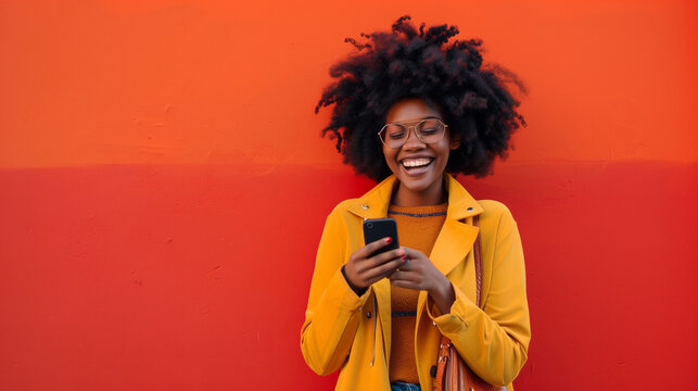 Portrait of beautiful black woman with purse looking at cellphone and laughing