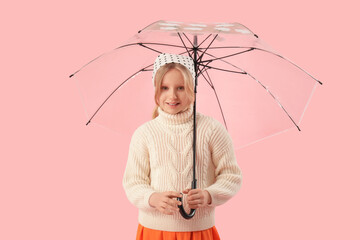 Adorable girl with umbrella on pink background
