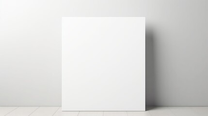 Blank white canvas leaning against a plain grey wall ready for artistic creation and design inspiration in a minimalist space.