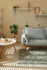Interior of stylish living room with grey sofa, soft carpet and coffee table