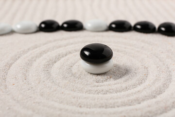 Stones on sand with lines in Japanese rock garden. Zen concept