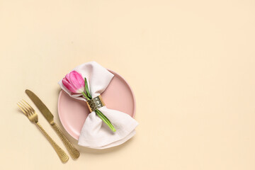 Table setting with tulip on beige background. Mother's day concept