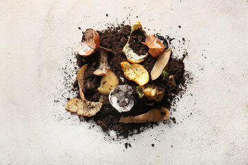 Organic waste and soil on white grunge background. Compost recycling concept