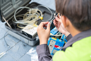 Technician ware sampling tube air quality in reel of machine pump.
