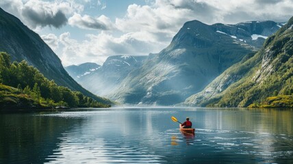 Man kayaking in serene mountain lake surrounded by lush greenery and majestic peaks under partly cloudy sky - Powered by Adobe